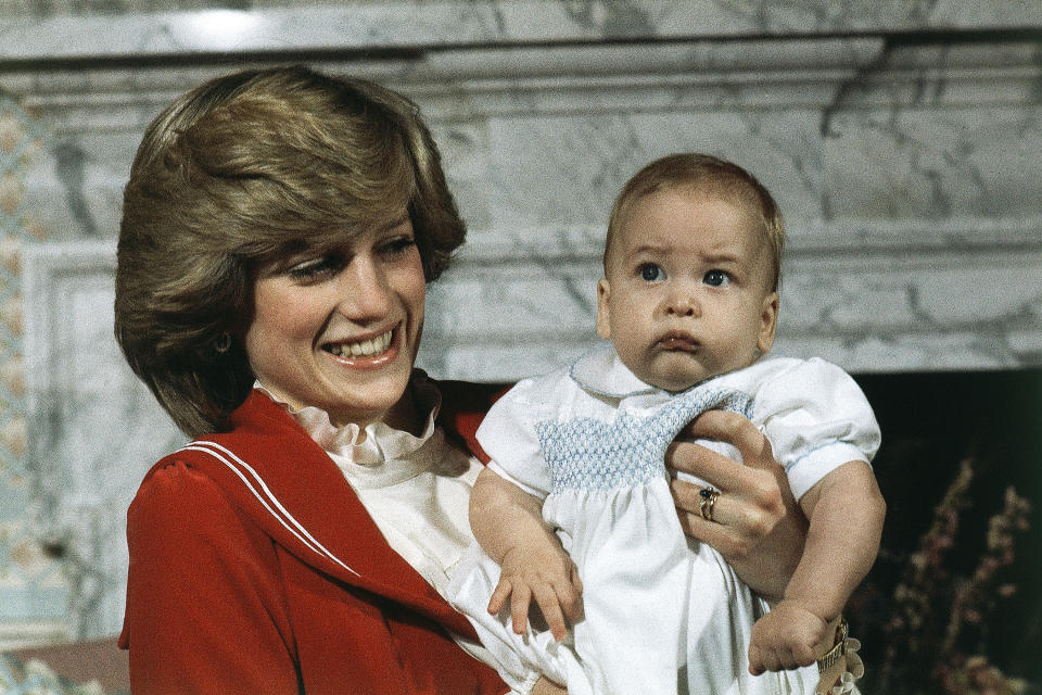 FILE - Britain's Prince William, the 6-month old son of Prince Charles and Princess Diana, with his mother during a photo call at Kensington Palace in London, England on Dec. 22, 1982. The world watched as Prince William grew from a towheaded schoolboy to a dashing air-sea rescue pilot to a father of three. But as he turns 40 on Tuesday, June 21, 2022, William is making the biggest change yet: assuming an increasingly central role in the royal family as he prepares for his eventual accession to the throne. (AP Photo/David Caulkin, File)
