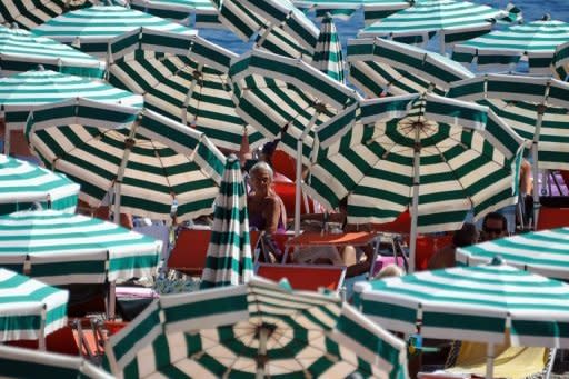 Holidaymakers sunbathe on a private beach near Santa Margherita Ligure, southern Genova. Thousands of Italy's private beaches kept their parasols closed in peak summer season on Friday in a symbolic protest against a new European Union directive that could force many to shut down