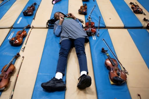 Tyrianna Graham, just eight years old, plays the violin in the OrchKids program, which provides safe haven for children after school, and even dinner for some