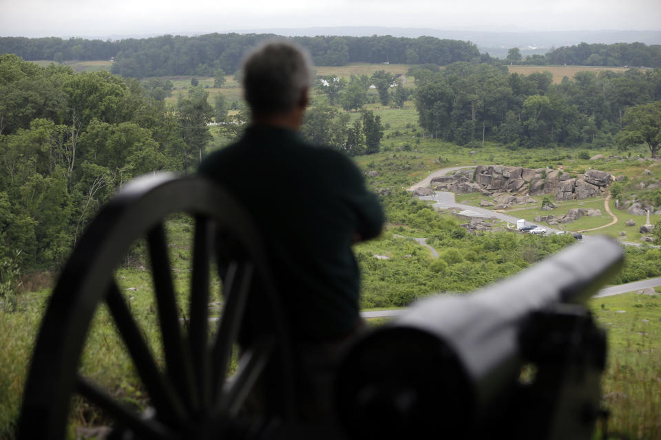A visitor to Little Round Top views the Devil's Den during ongoing activities commemorating the 150th anniversary of the Battle of Gettysburg, Monday, July 1, 2013, in Gettysburg, Pa. Union forces turned away a Confederate advance in the pivotal battle of the Civil War fought July 1-3, 1863, which was also the war’s bloodiest conflict with more than 51,000 casualties. (AP Photo/Matt Rourke)