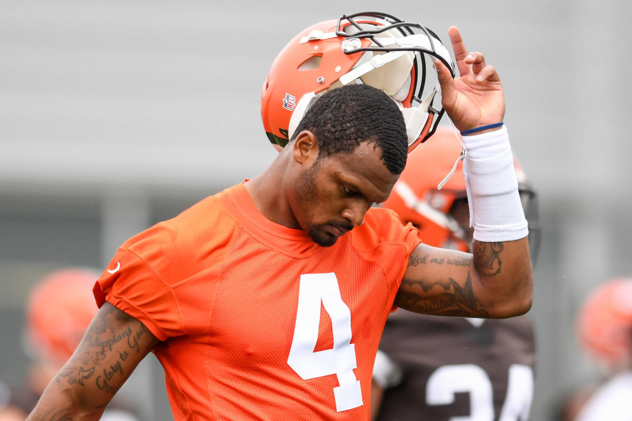 Deshaun Watson of the Cleveland Browns takes off his helmet as he warms up during the Cleveland Browns mandatory minicamp on June 14, 2022, in Berea, Ohio. (Nick Cammett / Getty Images file)