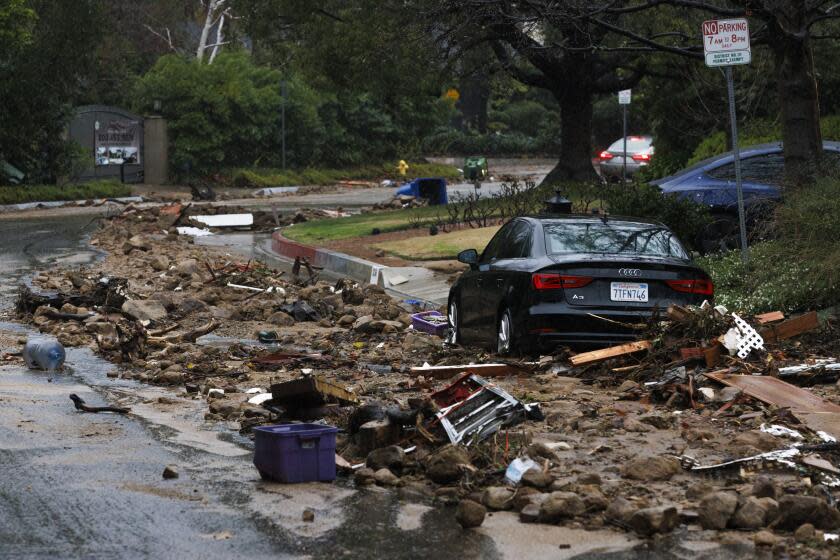 Studio City, CA - February 05: Debris line the street in front houses where 16 people and nine homes were evacuated due to a landslide from heavy rainfall during the atmospheric river hitting Calif. on Fryman Road on Monday, Feb. 5, 2024 in Studio City, CA. (Carlin Stiehl / for Los Angeles Times)