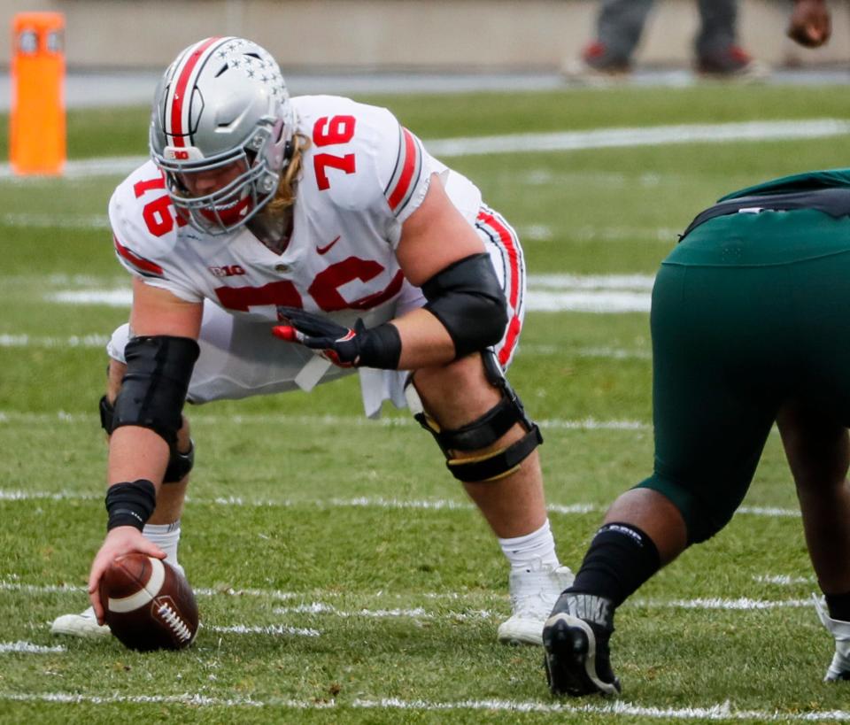 Ohio State Buckeyes offensive lineman Harry Miller (76) prepares to snap the ball during the first quarter of a NCAA Division I football game between the Michigan State Spartans and the Ohio State Buckeyes on Saturday, Dec. 5, 2020 at Spartan Stadium in East Lansing, Michigan.
