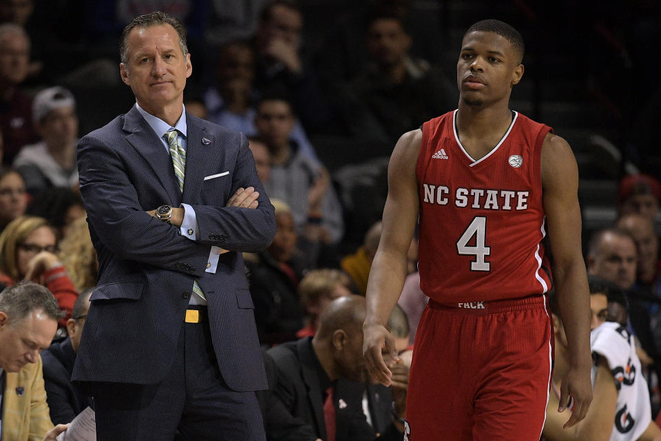 Former NC State coach Mark Gottfried (L) is shown with Dennis Smith Jr. during a 2017 ACC tournament game. (Getty)