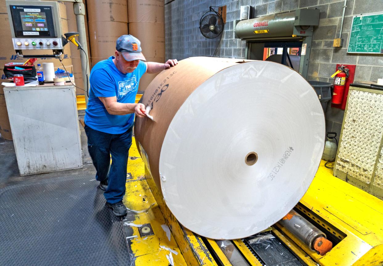 Dan Louzon unwraps a reel of paper for use on the printing press at the Pulliam Production Center, Monday, Feb. 26, 2024 in Indianapolis. The PPC is closing and had its last IndyStar printing on April 7, 2024 for the April 8, 2024 paper.