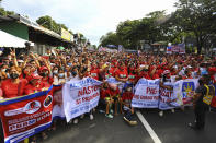 Supporters of new President Ferdinand Marcos Jr., wave the victory sign at a gathering along the Interim Batasang Pambansa Road just outside the House of Representatives Congress in Quezon City in Manila, as President Marcos Jr. delivered the first state of the nation address in Congress in Manila on Monday, July 25, 2022. (AP Photo/Gerard Carreon)