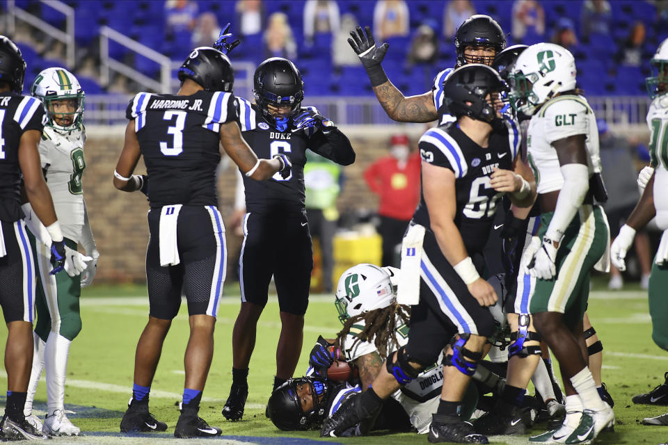 Duke wide receiver Jontavis Robertson (1) lies on the bottom of the pile after scoring a touchdown against Charlotte during the first half of an NCAA college football game Saturday, Oct. 31, 2020, in Durham, N.C. (Jaylynn Nash/Pool Photo via AP)