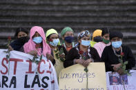 Women identified as victims of human rights violations during Guatemala's country's civil war, and their supporters, pray outside the Supreme Court in Guatemala City, Monday, Jan. 24, 2022. A decision at another, nearby court nearby is expected on Monday in the trial of five former civil defense patrolmen who fought alongside soldiers as civilians who are accused of sexual assault and human rights violations against dozens of Indigenous women from the Mayan Achi ethnic group. (AP Photo/Moises Castillo)