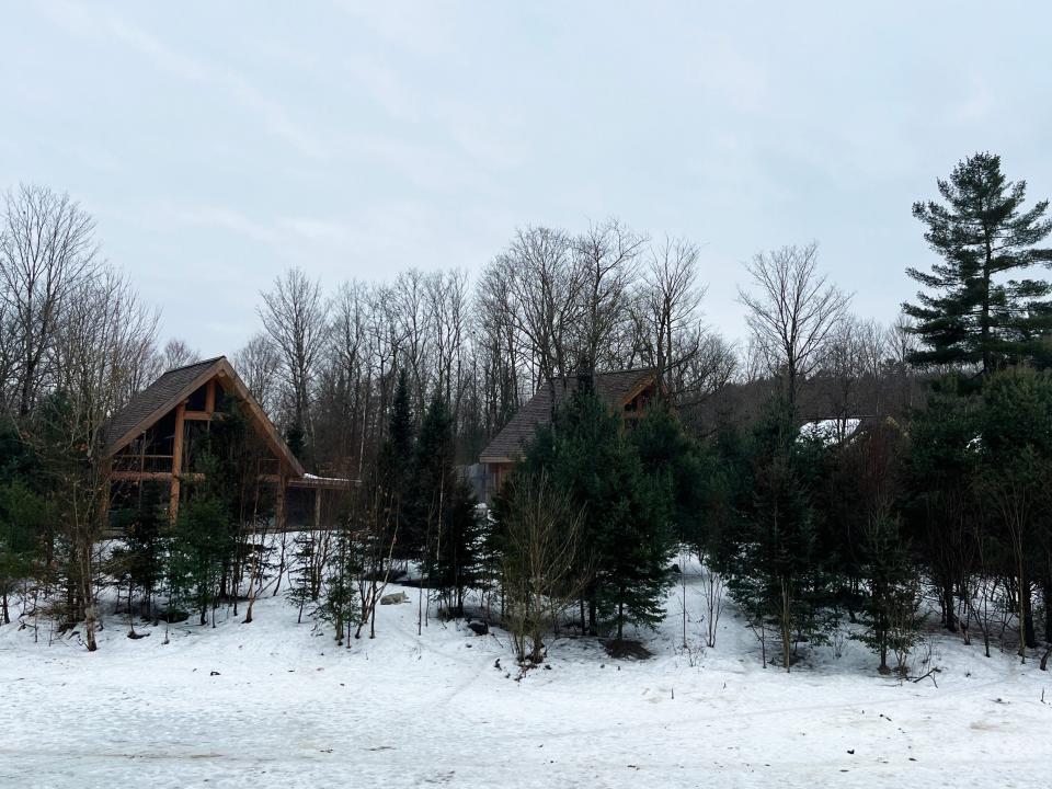Several cabins in the woods on snow-covered ground