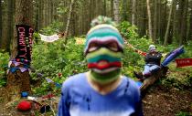 RNPS - PICTURES OF THE YEAR 2013 - Yarnbombers Purl 1 (L) and Knit 1 display some of the guerrilla knitting and crocheting which they plan to use when they target next week's G8 summit, in the Mourne Mountains, near Newcastle, County Down June 13, 2013. Yarnbombing uses knitting or crochet work to make a statement in public, rather than graffiti or street art. REUTERS/Cathal McNaughton (NORTHERN IRELAND - Tags: BUSINESS CIVIL UNREST POLITICS SOCIETY TPX)