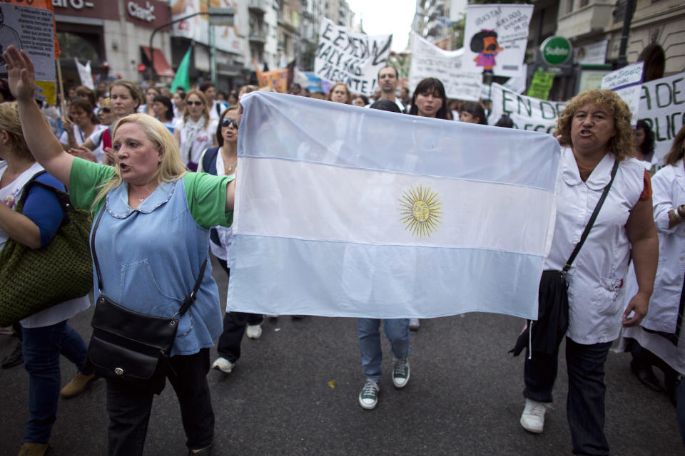 Teachers chant slogans as they march to the Ministry of Education in Buenos Aires, Argentina, Wednesday, March 26, 2014. Striking teachers in the Buenos Aires province are demanding a wage increase higher than what is currently being offered by the provincial administration. The strike is in its 15th day, affecting more than 3 million students. (AP Photo/Victor R. Caivano)