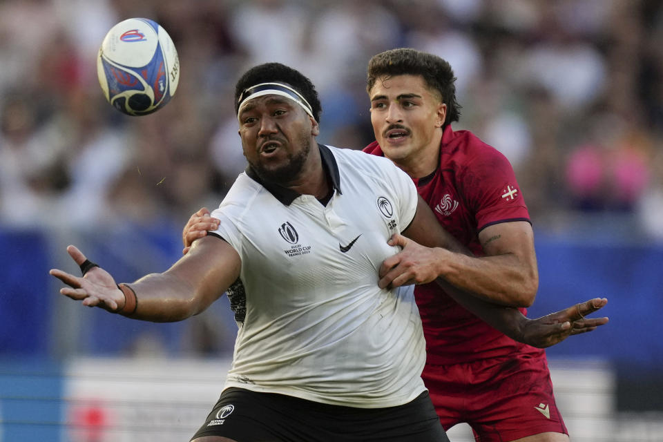 Fiji's Eroni Mawi, left, and Georgia's Davit Niniashvili, challenge for the ball during the Rugby World Cup Pool C match between Fiji and Georgia at the Stade de Bordeaux in Bordeaux, France, Saturday, Sept. 30, 2023. (AP Photo/Thibault Camus)