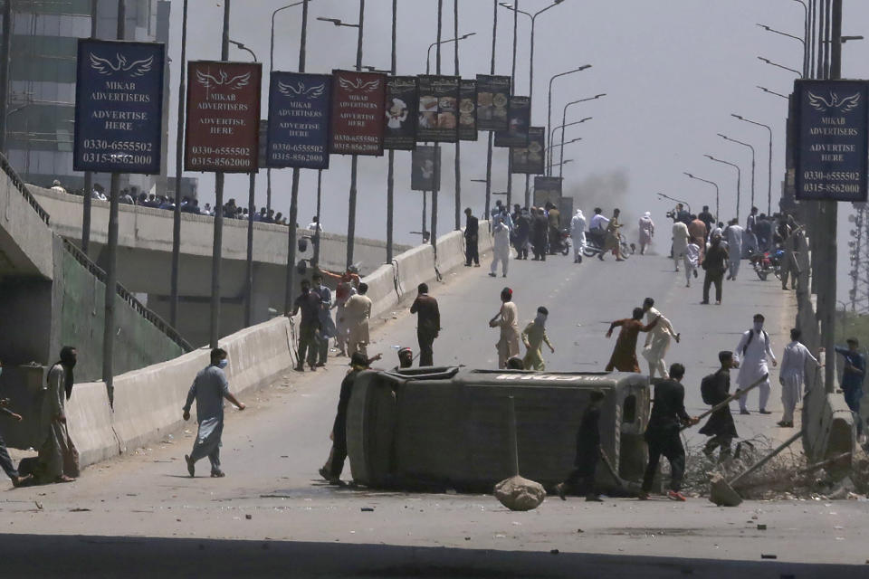 Supporters of Pakistan's former Prime Minister Imran Khan smash a police vehicle during a protest against the arrest of their leader, in Peshawar, Pakistan, Wednesday, May 10, 2023. A court has ruled that former Pakistani Prime Minister Imran Khan can be held for questioning for eight days. The decision Wednesday comes a day after the country’s popular opposition leader was dragged from a courtroom and arrested. His detention set off clashes between his supporters and police Tuesday. (AP Photo/Muhammad Sajjad)