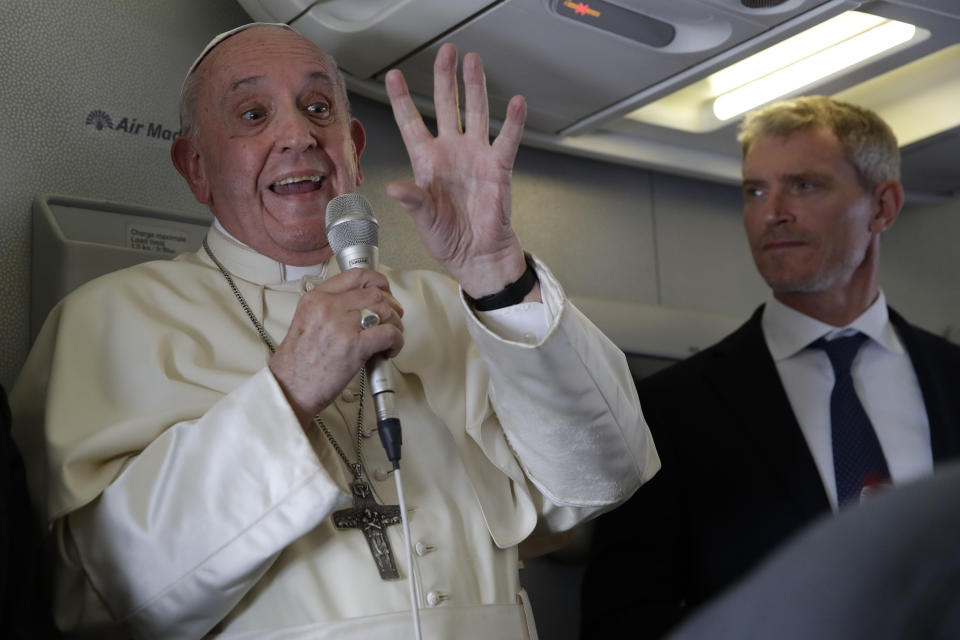 Pope Francis is flanked by his spokesperson Matteo Bruni, as he addresses journalists during his flight from Antamanarivo to Rome, Tuesday, Sept. 10, 2019, after his seven-day pastoral trip to Mozambique, Madagascar, and Mauritius. (AP Photo/Alessandra Tarantino)