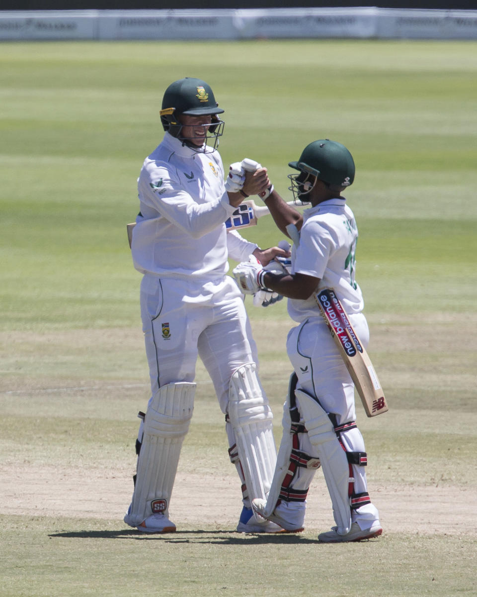 South African Batsman Rassie van Der Dussen and Temba Bavuma celebrate the winning runs to beat India 2-1 in a test series between South Africa and India in Cape Town, South Africa, Friday, Jan. 14, 2022. (AP Photo/Halden Krog)