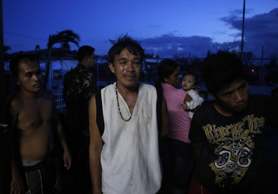 Survivors of super Typhoon Haiyan wait for medical assistance outside an airport in typhoon battered Tacloban city, in central Philippines