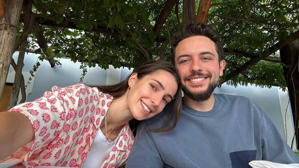 Princess Rjwa and His Royal Highness Crown Prince Al Hussein pose for a selfie. Rajwa wears a cream and pink shirt where Hussein wears a blue t-shirt 