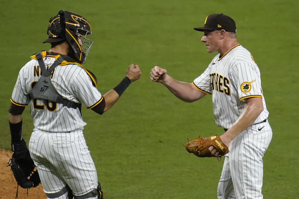 San Diego Padres relief pitcher Mark Melancon, right, celebrates with catcher Austin Nola after the Padres defeated the Pittsburgh Pirates 2-0 in a baseball game Monday, May 3, 2021, in San Diego. (AP Photo/Gregory Bull)