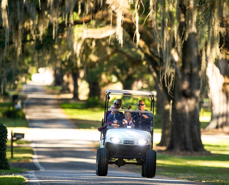 This 2019 file photo shows the Ingram family riding a golf cart along Southeast Seventh Street in Ocala.