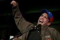 Venezuelan opposition leader Henrique Capriles speaks to supporters and reporters during a meeting in Caracas, Venezuela, Friday, April, 7, 2017. Capriles announced that he has been banned from running for office for 15 years, a move sure to ratchet up tensions amid a growing street protest movement. (AP Photo/Ariana Cubillos)