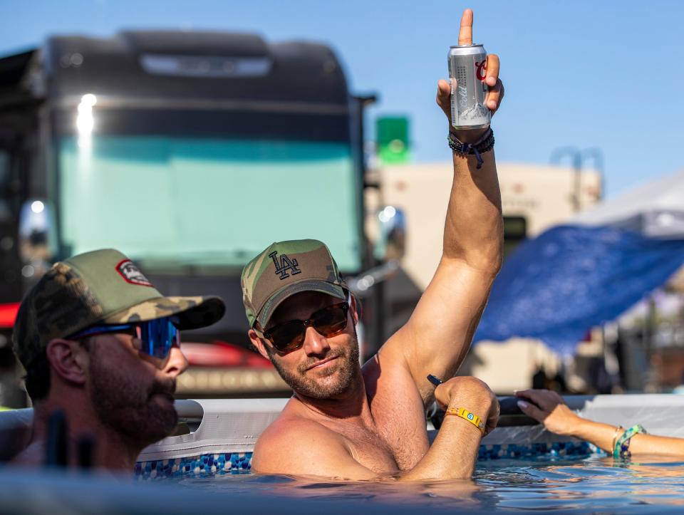 Brett Saunders of Thousand Oaks poses for the camera in The Resort camping area at Stagecoach at the Empire Polo Club in Indio, Calif., Saturday, April 29, 2023. 