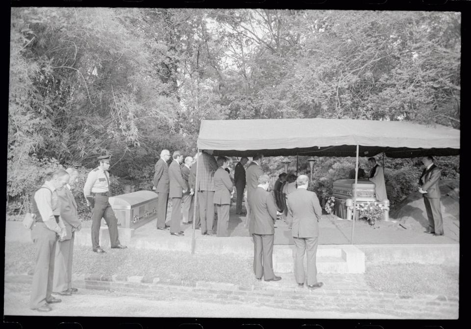 Mourners gather for graveside services for recluse billionaire Howard Hughes. Hughes was buried alongside his mother and father in a private sunrise service at a century old cemetery near downtown Houston.