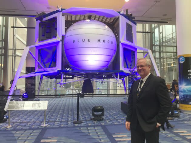 GeekWire’s Alan Boyle has his moment with Blue Origin’s Blue Moon lander at the International Astronautical Congress in Washington, D.C. (GeekWire Photo)