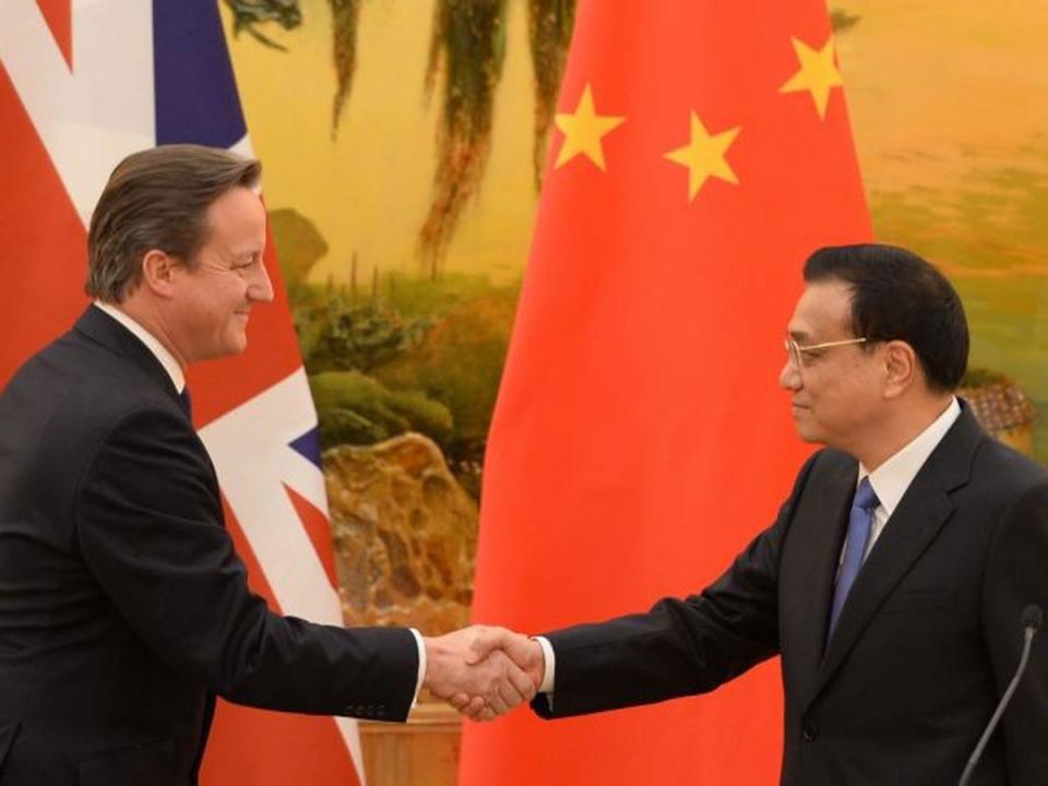 David Cameron shakes hands with Li Keqiang, the former Chinese premier, in 2013 (PA)