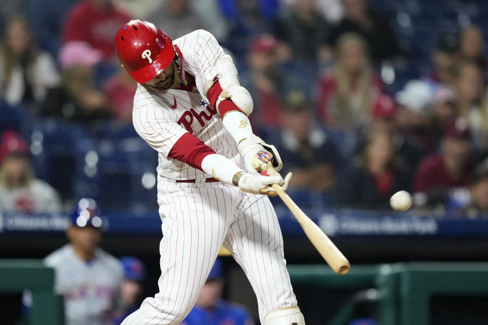 Philadelphia Phillies' Nick Castellanos hits a two-run home run against New York Mets pitcher Jose Butto during the fourth inning of a baseball game, Sunday, Sept. 24, 2023, in Philadelphia. (AP Photo/Matt Slocum)