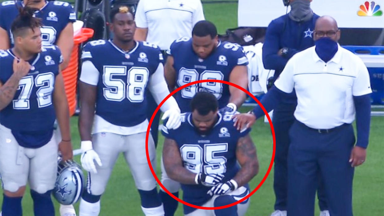 Pictured here, Cowboys player Dontari Poe kneels during the anthem before an NFL match.
