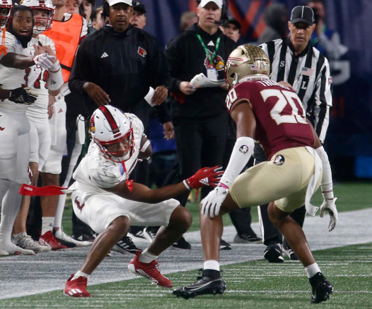 Louisville’s Jamari Thrash caught the pass for the first down against FSU’s Azareye’h Thomas in the AAC Football Championship game. 
Dec. 2, 2023