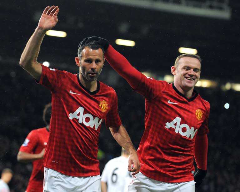 Manchester United's Ryan Giggs (L) celebrates with Wayne Rooney after scoring a penalty during their 4-1 FA Cup football win over Fulham at Old Trafford on January 26, 2013