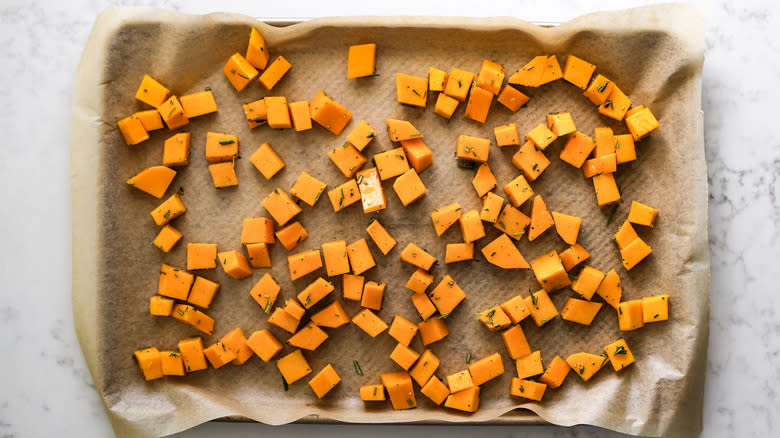 roasted butternut squash cubes on baking sheet