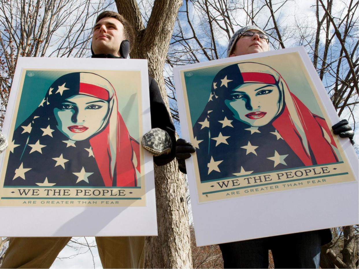 Demonstrators gather near The White House to protest President Donald Trump's travel ban on six Muslim countries on 11 March 2017. Mr Trump took to Twitter to attack the courts and Democrats for trying to block it: TASOS KATOPODIS/AFP/Getty Images