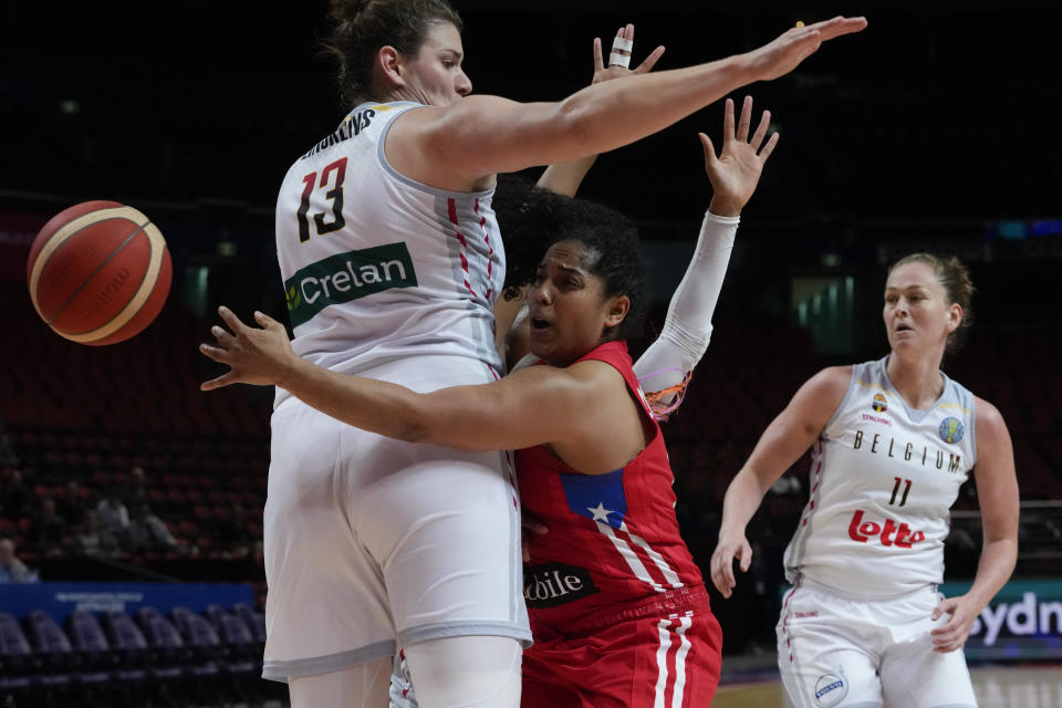 Puerto Rico's Jennifer O'Neill passes the ball behind Belgium's Kyara Linskens during their game at the women's Basketball World Cup in Sydney, Australia, Saturday, Sept. 24, 2022. (AP Photo/Mark Baker)