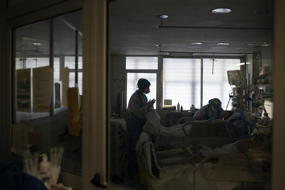 Healthcare workers assist COVID-19 patients at one of the intensive care units (ICU) of the Germans Trias i Pujol hospital in Badalona, Barcelona province, Spain, Wednesday, April 1, 2020. The new coronavirus causes mild or moderate symptoms for most people, but for some, especially older adults and people with existing health problems, it can cause more severe illness or death. (AP Photo/Felipe Dana)