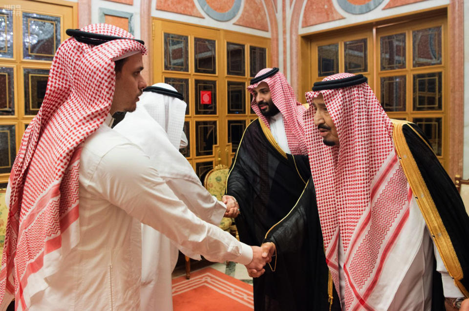 In this photo released by Saudi Press Agency, SPA, Saudi King Salman, right, and Crown Prince Mohammed bin Salman, second right, receive Sahel, a family member, and Salah, a son, of Jamal Khashoggi, in Riyadh, Saudi Arabia, Tuesday, Oct. 23, 2018. Saudi Arabia, which for weeks maintained that Jamal Khashoggi had left the Istanbul consulate, on Saturday acknowledged he was killed there in a "fistfight." (Saudi Press Agency via AP)