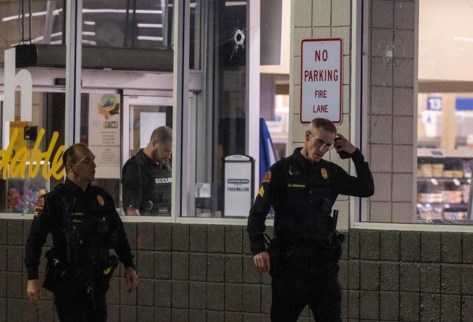 Police investigate the scene of a shooting at the Raleigh Boulevard Shopping Center Monday night, March 27, 2023.