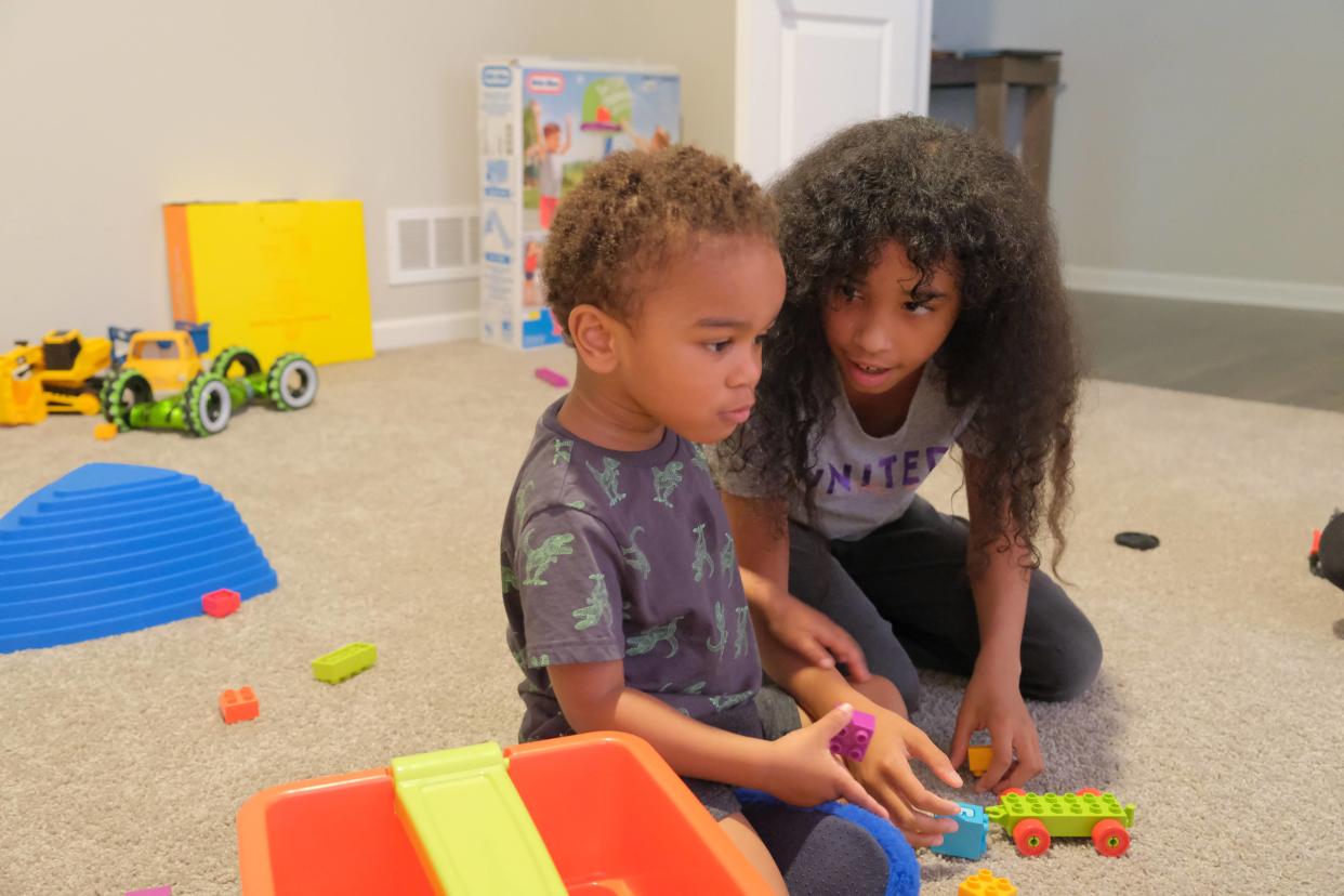 Zaire “Rico” McCurdy, 3, plays with his older sister, Amilliana McCurdy, 10, in their Pataskala home. Rico is on the autism spectrum and his playroom is filled with sensory toys. His sister enjoys playing with him and helping him learn things like colors and letters.