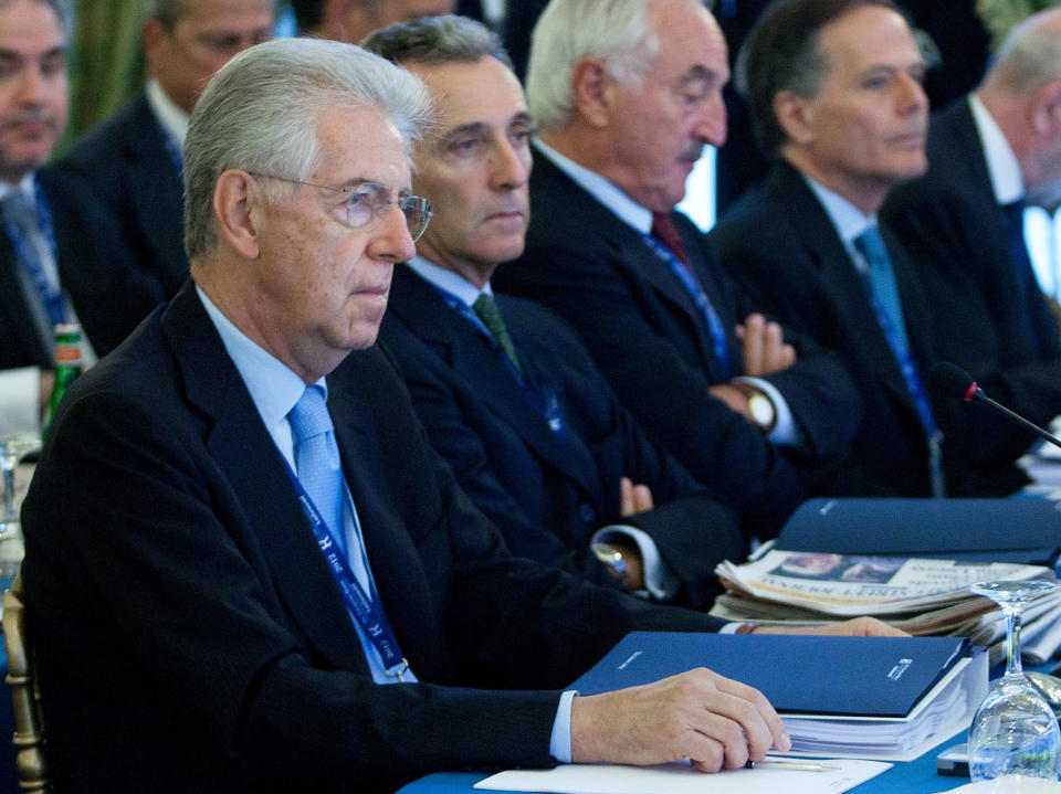 Italian Premier Mario Monti, foreground, flanked by Italian Finance Minister Vittorio Grilli, attends a meeting on World Economy in Cernobbio, Italy, Saturday, Sept. 8, 2012. Grilli says Italy has no plans to apply for the European Central Bank's bond purchase program. Italian Finance Minister said on the sidelines of the annual Ambrosetti Forum on Lake Como on Saturday that Italy "at this moment absolutely does not need" to request help. (AP Photo/Roberto Monaldo, Lapresse)