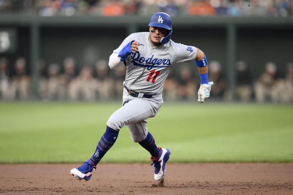 Los Angeles Dodgers' Miguel Rojas runs towards third on a single by James Outman during the second inning of a baseball game against the Baltimore Orioles, Tuesday, July 18, 2023, in Baltimore. (AP Photo/Nick Wass)