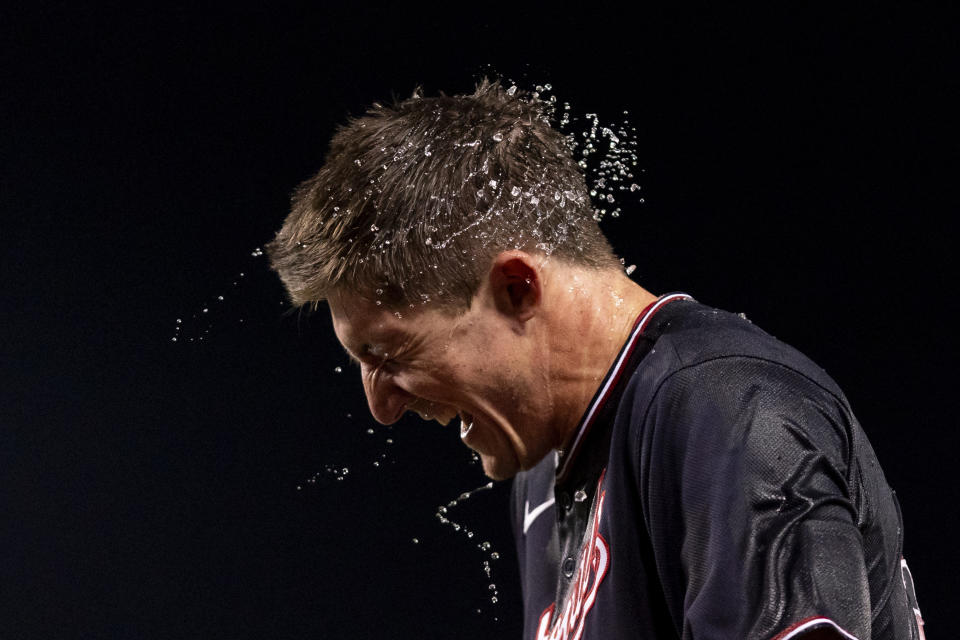 Washington Nationals' Jacob Young is doused in water after hitting a walk-off single during the ninth inning of a baseball game against the New York Mets, Wednesday, Sept. 6, 2023, in Washington. (AP Photo/Stephanie Scarbrough)