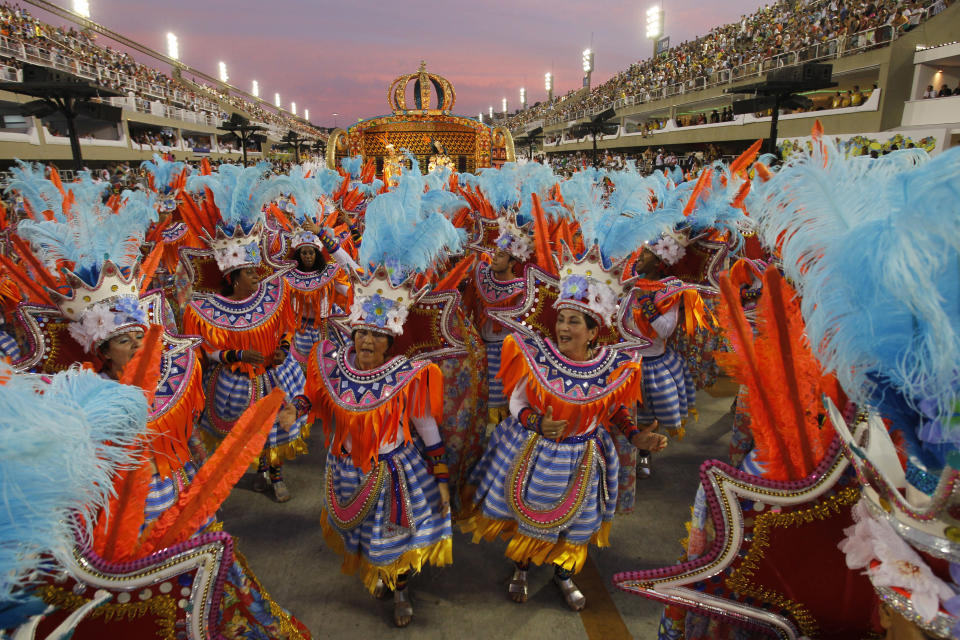 Performers from the Unidos da Vila Isabel samba school parade during carnival celebrations at the Sambadrome in Rio de Janeiro, Brazil, Monday, Feb.20, 2012.   Millions watched the sequin-clad samba dancers at Rio de Janeiro's iconic Carnival parade.  (AP Photo/Victor R. Caivano)