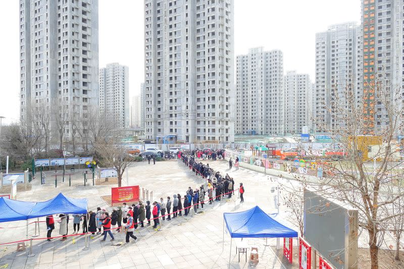 FILE PHOTO: People line up in the Chinese city of Tianjin for nucleic acid testing for the coronavirus disease (COVID-19) in January