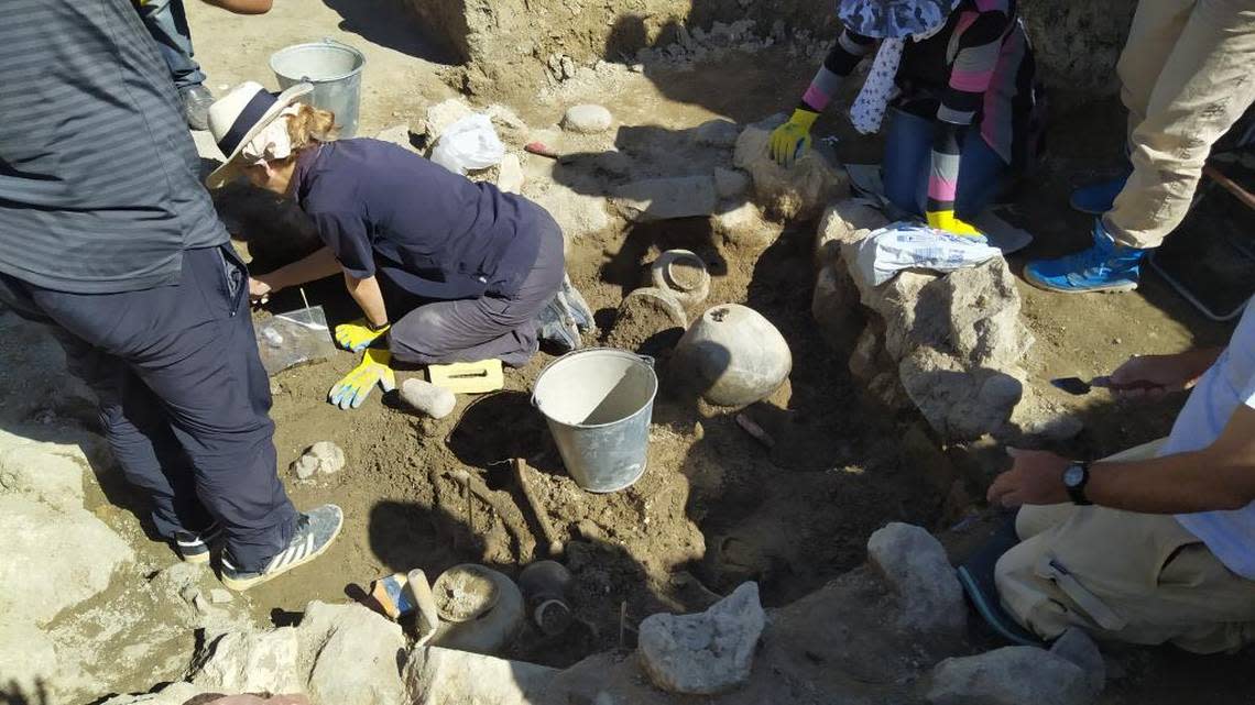 Archaeologists work to excavate the tomb.