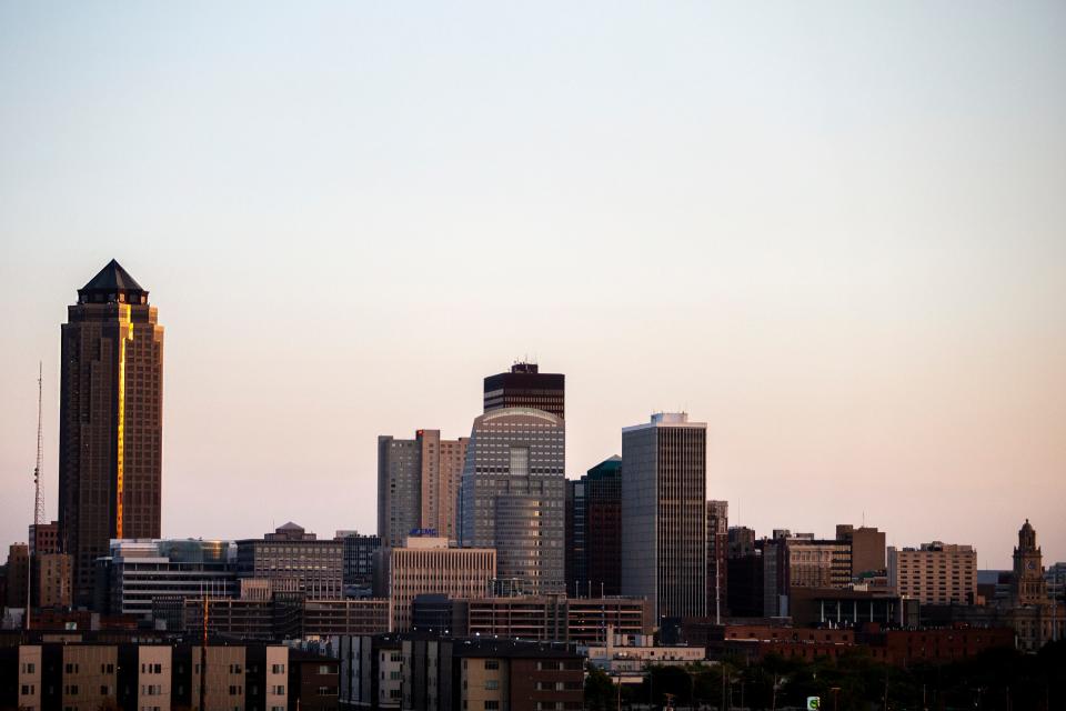 The first rays of sun hit the downtown Des Moines skyline as seen from the MacRae Park overlook in Des Moines.