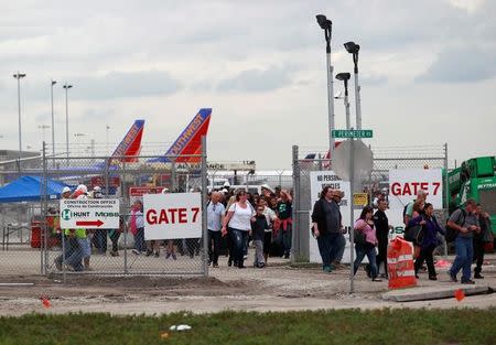 People exit the airport perimeter following a shooting incident at Fort Lauderdale-Hollywood International Airport in Fort Lauderdale, Florida, U.S. January 6, 2017. REUTERS/Andrew Innerarity