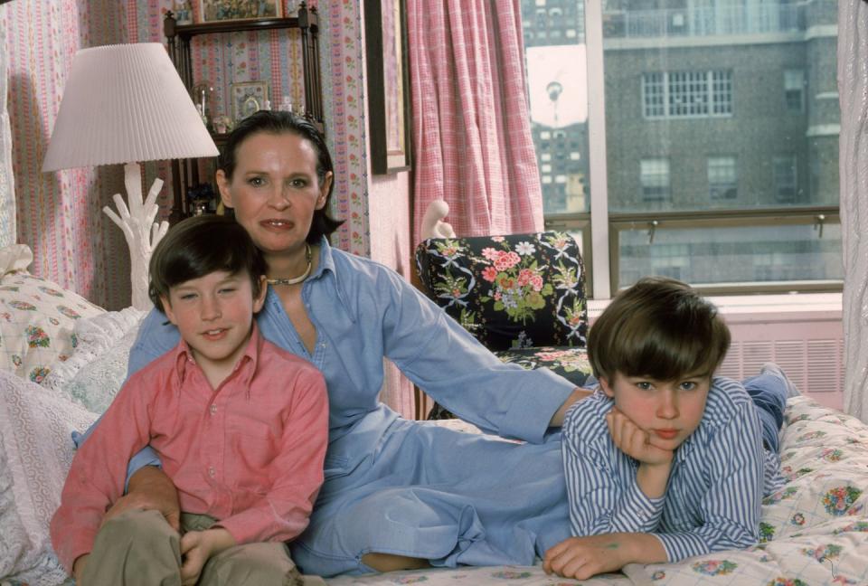 <p>Anderson Cooper sits by his mother, Gloria Vanderbilt, and brother, Carter, in his childhood home in New York City in 1976. </p>