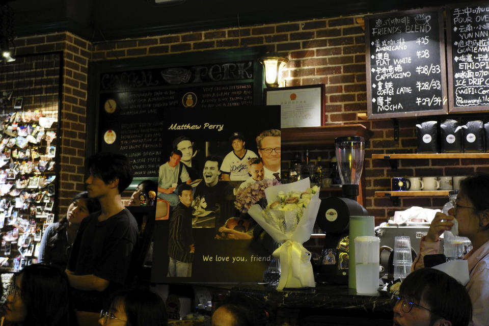In this photo released by Nie Yanxia, dans gather at a memorial for Matthew Perry, the actor who played Chandler in the hit sit-com "Friends," in a cafe styled to look like the setting in the series in Shenzhen in southern China, on Nov. 1, 2023. Long before "Friends" made its official debut in China, the show was a word-of-mouth phenomenon in the country. In the wake of Matthew Perry's death at 54, fans in China are mourning the loss of the star who felt less like a distant celebrity and more like an old friend. (Nie Yanxia via AP)