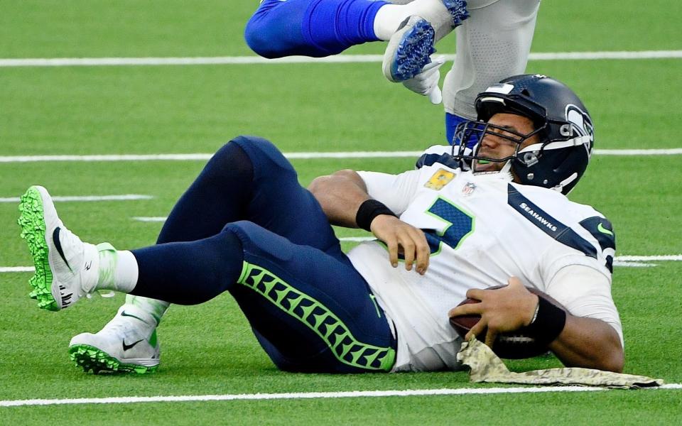 Seattle Seahawks quarterback Russell Wilson (3) reacts after getting sacked by Los Angeles Rams outside linebacker Leonard Floyd (54) during the second half at SoFi Stadium.  - Robert Hanashiro-USA TODAY Sports